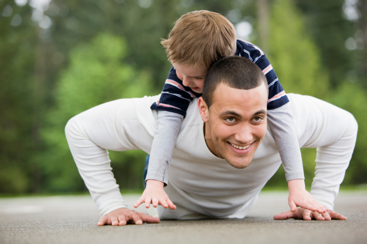 MR boy (age 6) on back of man (age 25) while doing pushups