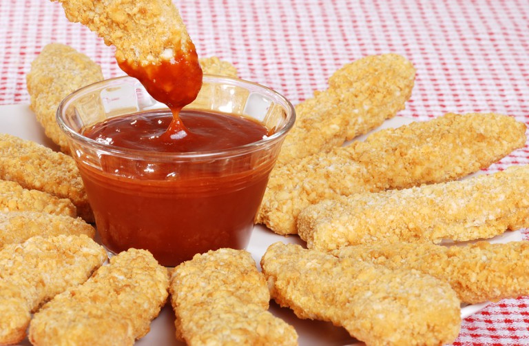 closeup BBQ sauce with chicken fingers Women Daily Magazine