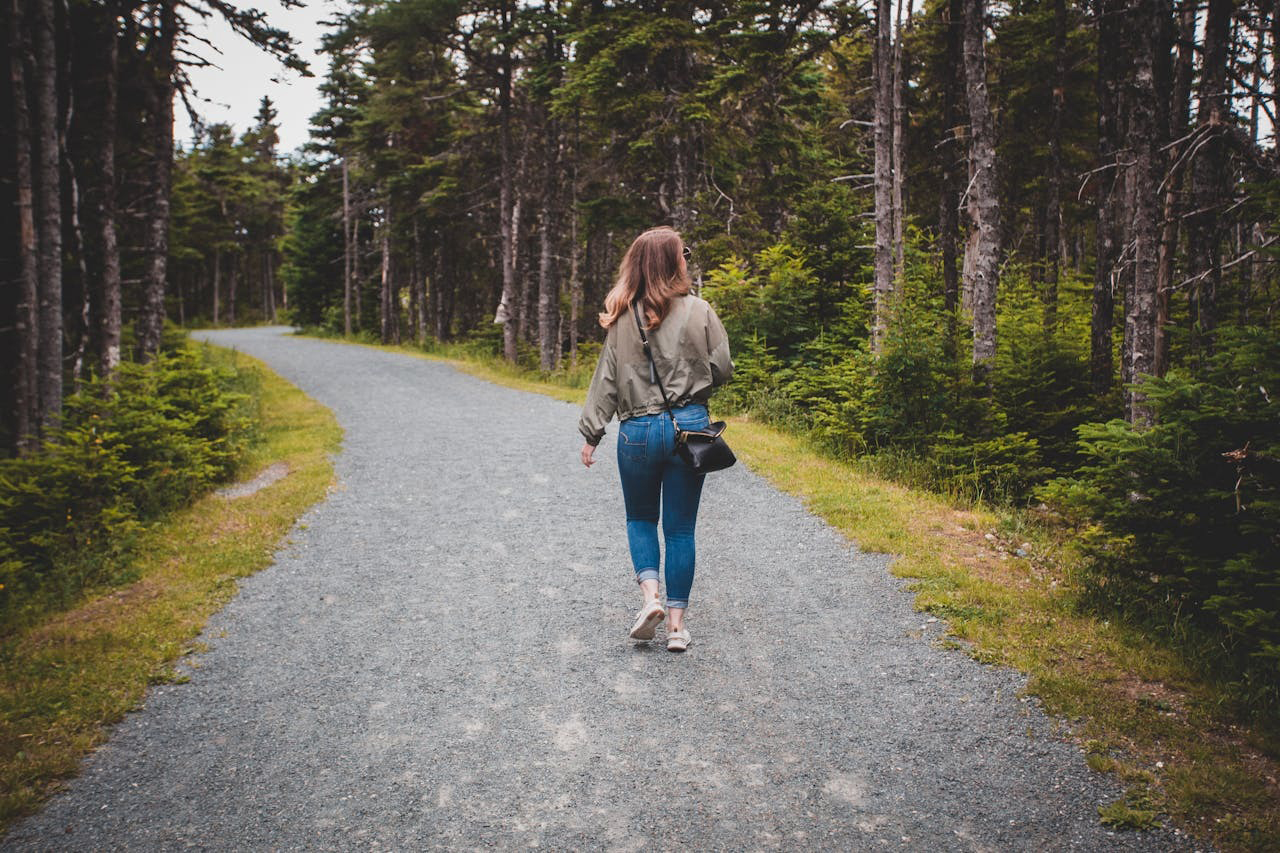Woman solo hiker enjoying scenic mountain trail in Europe